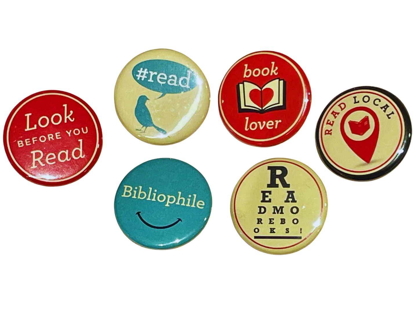 Set of colorful buttons with book-themed designs on a white background