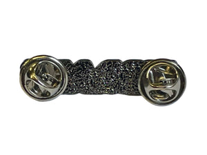 the back of a silver colored enamel pin with two fasteners